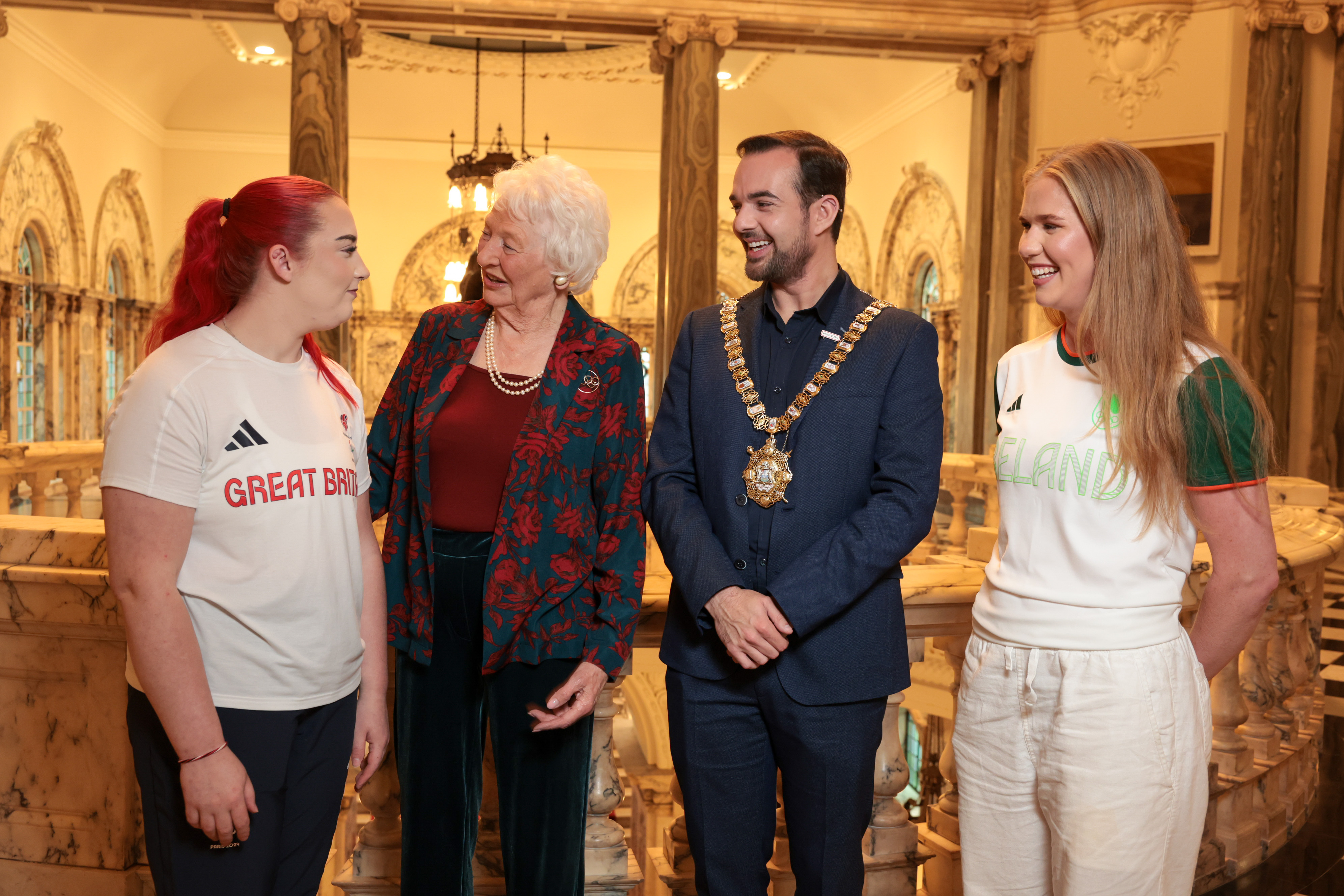 Lord Mayor of Belfast, Councillor Micky Murray, and Lady Mary Peters chat to Olympians Katie Morrow and Erin Creighton at City Hall.
