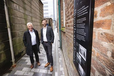 Gerry McAlinden DfC and Cllr Sam Nelson officially reopen Sugarhouse Entry after more than half a century