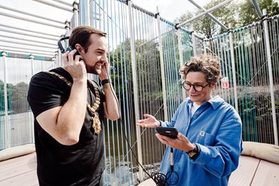 Sound artist Dr Matilde Meireles invites Lord Mayor of Belfast, Councillor Micky Murray, to listen to the sounds of the river on board DRIFT, one of several Belfast 2024 projects to get underway this