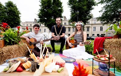 Lord Mayor Councillor Micky Murray with Seán Smyth and Susie Kerr - both holding guitars - on a picnic blanket Crescent Gardens