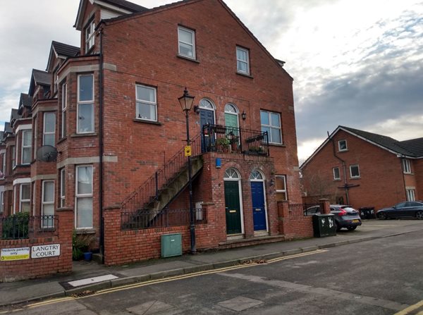 Red brick flats with external staircase providing direct access to the street.